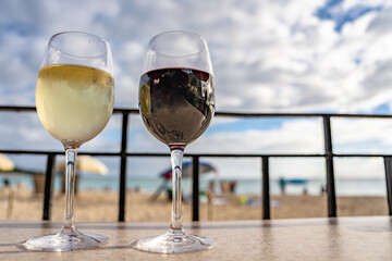Two wine glasses for a romantic evening at the beach in Honolulu, Hawaii.