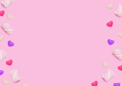 Sweets. Top view photo with copy space. Swirl marshmallows and heart shaped colorful candies on pink background