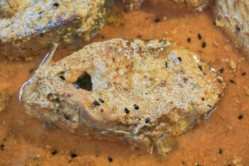 Tenualosa ilisha (ilish, hilsa, hilsa herring or hilsa shad) fish pieces on plate, spicy Indian dish. It is Bangladesh's national fish. Hugely popular amongst Bengalis and south Asia for it's taste.