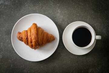 fresh croissant on white plate