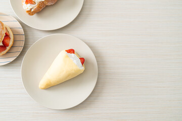 fresh strawberry cream crepe on plate