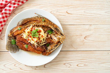 Fried Sea Bass Fish with Fish Sauce and Spicy Salad