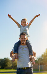 Days with dad are just the best. Shot of a father carrying his little son on his shoulders while...