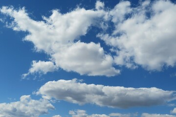 Naklejka na ściany i meble Blue sky with beautiful white fluffy clouds