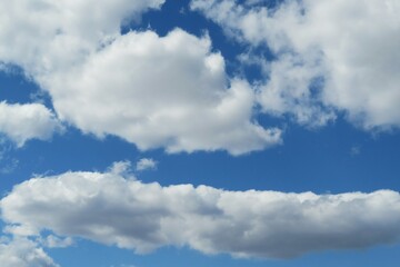 Naklejka na ściany i meble Blue sky with beautiful white shapes clouds