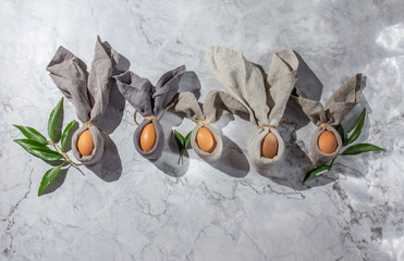 Festive easter background with Easter bunny eggs on linen napkin. Easter decoration, top view. Copy space