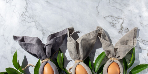 Festive easter background with Easter bunny eggs on linen napkin. Easter decoration, top view. Copy space