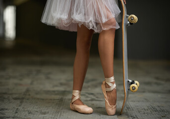 Grace on wheels. A cropped image of a woman in ballet slippers on a skateboard. - obrazy, fototapety, plakaty