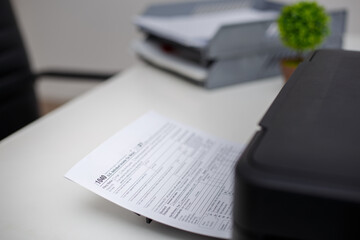 Obraz premium Tax documents are being printed from the printer, Tax payment concept, State Government taxation, Forms government, Paperwork, Report.