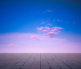 pink clouds, blue sky, gray floor.