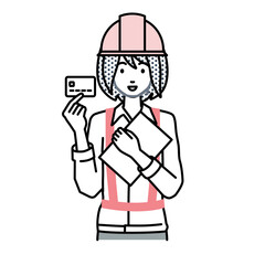立って書類とカードを手に持つ工事現場の女性