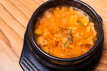 Kimchi soup in hot black iron pot, Korean traditional Kimchi Jjigae soup in bowl in the restaurant, Japanese hot pot food