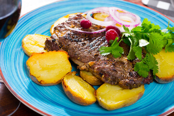 Delicious roasted beef steak with baked potato, fresh onion and parsley