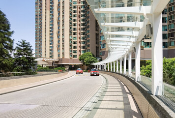 partially sheltered footbridge in residential areas in Hong Kong, China during a sunny day