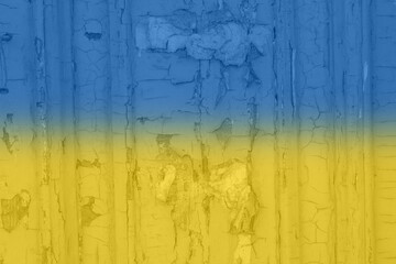 Ukrainian flag on a textured background. The flag of Ukraine on the old grunge wall in the background, the concept of destruction and war in Ukraine.Support for Ukrainians in the war with Russia