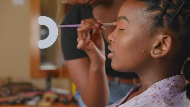 Makeup being applied to woman face