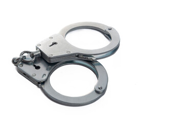 Metal handcuffs on a white isolated background, copy space