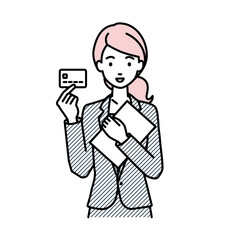 立って書類とカードを手に持つビジネススーツの女性