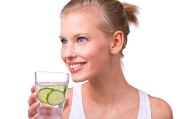 Zest for life. Shot of a beautiful young woman with a glass of water with cucumber slices isolated...