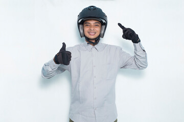 handsome asian man with a motorcycle helmet showing a thumbs up ok gesture on white background
