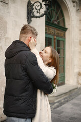 Romantic couple hugging while walking in the street of old town