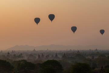 Beautiful view of hot-air balloons over temples and pagodas at the ancient plain of Bagan in Myanmar (Burma) at sunrise.