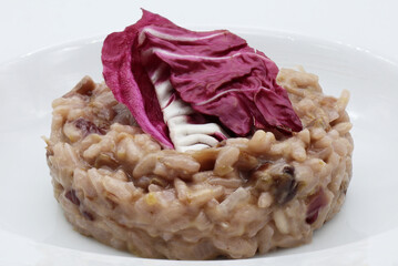 Risotto with red radicchio in a white dish. Italian cuisine.