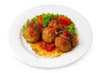 Meat balls with vegetables on white plate isolated on white