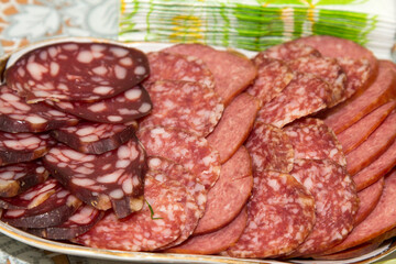 Cut sausage of sausage of different varieties on a plate