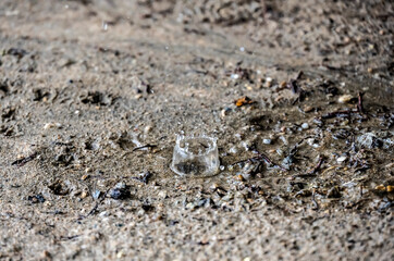 raindrops fall on brown sand and create magical shapes 