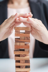 Businesswoman hand cover wooden block on the tower. Business planning, Risk Management, Solution,...