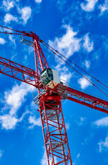New construction site with crane on blue sky background. Steel frame structure, structural steel beam, construction business.