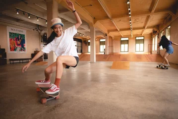 Foto op Aluminium skater woman person playing skateboard in sport gym, young Asian woman are happy and fun with skateboarding lifestyle in city, teenage hipster female trendy fashion © chokniti