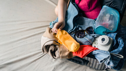Close up messy belongings such as sunglasses, polaroid camera, cosmetic bag and small bag, try to...