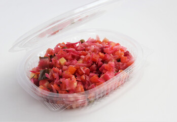Salad in individual plastic disposable packaging. The vinaigrette.