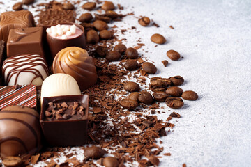 Chocolate candies and chocolate pieces pile for background