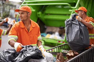 Garbage collection day. Cropped shot of a garbage collection team at work.