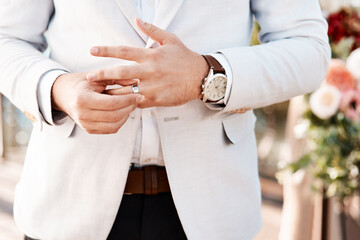 This ring will always be on his finger. Cropped shot of an unrecognizable bridegroom adjusting his ring on his wedding day.