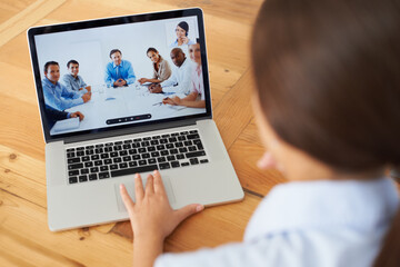 Video conference in progress.... Rear view of a young businesswoman in a video conference with her...