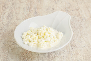 Grained cottage cheese in the bowl