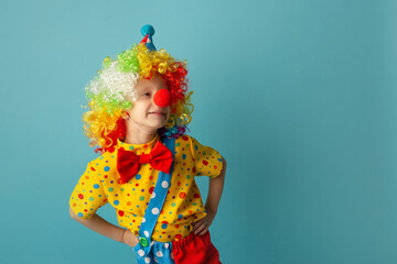 Funny kid clown against blue background. 1 April Fool's day concept