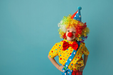 Funny kid clown against blue background. 1 April Fool's day concept
