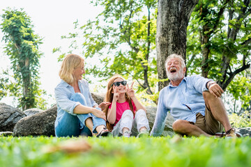 Happy family parent and child relax in weekend holiday lifestyle park outdoor nature background.