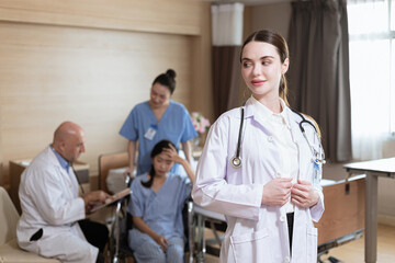 beautiful female doctor standing for portrait Doctor's background with patients and medical students