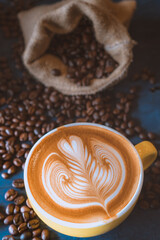 coffee latte art on wood table, relax time, cafe barista art top view.
