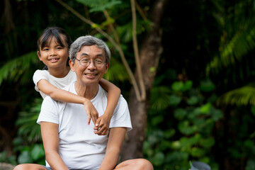 Happiness old man and little girl in park.