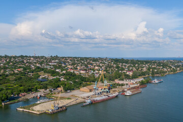 Fototapeta na wymiar Nikopol river port from above. Photo of barges in the water. Summer sunny day.