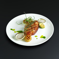traditional dishes of European cuisine, delicacy, banquet snack. culinary dishes on a white plate on a black background. restaurant service