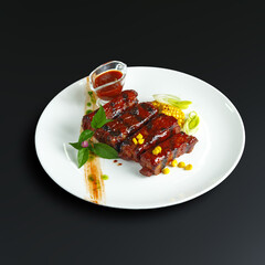 traditional dishes of European cuisine, delicacy, banquet snack. culinary dishes on a white plate on a black background. restaurant service