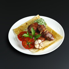 traditional dishes of European cuisine, delicacy, banquet snack. culinary dishes on a white plate on a black background. restaurant service